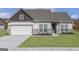 Charming single-Gathering home features a well-manicured lawn, two-car garage, and inviting entryway at 539 Cantrell Drive, Dallas, GA 30157