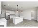 Spacious kitchen with white cabinets, stainless appliances, and island with sink and pendant lights at 539 Cantrell Drive, Dallas, GA 30157