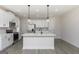Modern kitchen features a large island with pendant lighting and stainless steel appliances at 539 Cantrell Drive, Dallas, GA 30157