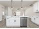 This modern kitchen features white cabinets, stainless steel appliances, and a center island with bar seating at 539 Cantrell Drive, Dallas, GA 30157