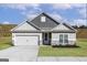 Charming single-Gathering home with gray siding, a two-car garage, and well-manicured lawn at 601 Cantrell Drive, Dallas, GA 30157