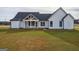 Expansive backyard featuring a modern farmhouse with a covered porch at 4751 H D Atha Rd, Covington, GA 30014