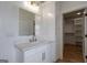 Bright bathroom features granite countertop, white vanity, modern fixtures, and view to walk-in closet at 4751 H D Atha Rd, Covington, GA 30014