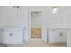 Bathroom vanity features double sinks, white cabinetry, marble countertops, and modern fixtures, illuminated by stylish sconces at 4751 H D Atha Rd, Covington, GA 30014