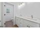 Bright bathroom vanity showcases double sinks, white cabinetry, marble countertops, and modern fixtures for a luxurious feel at 4751 H D Atha Rd, Covington, GA 30014