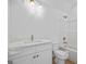 Well lit bathroom featuring white vanity, toilet, tub, and gold fixtures at 4751 H D Atha Rd, Covington, GA 30014