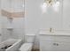 Bright bathroom featuring tiled walls, a tub, a toilet, and a vanity with modern fixtures at 4751 H D Atha Rd, Covington, GA 30014