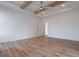 Large bedroom featuring wood floors, ceiling fan and lights, and view to bathroom at 4751 H D Atha Rd, Covington, GA 30014