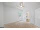 Minimal bedroom features a ceiling fan, natural light, and an ensuite bathroom at 4751 H D Atha Rd, Covington, GA 30014