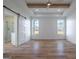 Spacious bedroom with hardwood floors, ceiling fan and light, large windows, and barn door to bathroom at 4751 H D Atha Rd, Covington, GA 30014