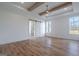 Bright bedroom with hardwood floors, ceiling fan and lights, large windows, and barn door to bathroom at 4751 H D Atha Rd, Covington, GA 30014