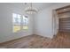 Bright dining room featuring wood floors, modern chandelier, and large windows with outside view at 4751 H D Atha Rd, Covington, GA 30014