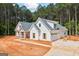 New home featuring white exterior, a gray roof, an attached garage and a concrete driveway at 4751 H D Atha Rd, Covington, GA 30014