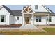 Beautiful modern farmhouse showcasing a welcoming front entrance and manicured landscaping at 4751 H D Atha Rd, Covington, GA 30014
