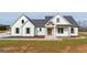 Charming white farmhouse with black roof, green shutters, and lovely landscaping at 4751 H D Atha Rd, Covington, GA 30014