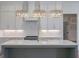 Stylish kitchen featuring a central island, white cabinetry, and modern appliances at 4751 H D Atha Rd, Covington, GA 30014