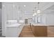 Spacious kitchen featuring white cabinets, marble countertops, gold hardware, and hardwood floors at 4751 H D Atha Rd, Covington, GA 30014