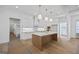 Bright kitchen with white cabinets, marble countertops and gold hardware complements light hardwood flooring at 4751 H D Atha Rd, Covington, GA 30014