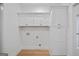 Bright, white laundry room featuring cabinets, storage, and connections for appliances in new home at 4751 H D Atha Rd, Covington, GA 30014