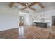 Open-concept living area with a kitchen island, modern appliances, and wood flooring at 4751 H D Atha Rd, Covington, GA 30014