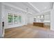 Open living room with hardwood floors flowing into the kitchen of a bright modern home at 4751 H D Atha Rd, Covington, GA 30014