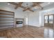 Spacious living room with wood beams, fireplace, and built-in bookshelves at 4751 H D Atha Rd, Covington, GA 30014