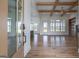 Open-concept living room with hardwood floors, wood beams, and plenty of natural light at 4751 H D Atha Rd, Covington, GA 30014