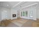 Bright living room featuring a cozy fireplace, hardwood floors, and natural light at 4751 H D Atha Rd, Covington, GA 30014