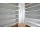 Bright pantry features custom white shelving, hardwood floors, and natural light from the window at 4751 H D Atha Rd, Covington, GA 30014
