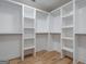 Spacious walk-in closet features custom white shelving and wood floors at 4751 H D Atha Rd, Covington, GA 30014