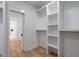 Large walk-in closet features custom white shelving and storage space at 4751 H D Atha Rd, Covington, GA 30014