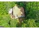 Aerial view of the home showing the roof, landscaping, and surrounding mature trees at 205 N Strathmore Dr, Sharpsburg, GA 30277