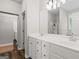 Bright bathroom features double sink vanity with storage, framed mirror and glass enclosed shower at 205 N Strathmore Dr, Sharpsburg, GA 30277