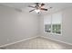 Bright bedroom with a ceiling fan, neutral paint, and a window providing natural light at 205 N Strathmore Dr, Sharpsburg, GA 30277