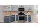 Updated kitchen features stainless steel appliances and light-colored cabinetry at 205 N Strathmore Dr, Sharpsburg, GA 30277