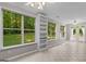 Open living space featuring large windows with backyard views, built in shelves and a ceiling fan at 205 N Strathmore Dr, Sharpsburg, GA 30277