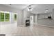 Spacious living room with a cozy fireplace and open access to the kitchen and backyard at 205 N Strathmore Dr, Sharpsburg, GA 30277