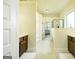 Large bathroom features double vanities, neutral tile floor, and glass enclosed shower at 2589 Lake Erma Dr, Hampton, GA 30228