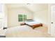 Inviting bedroom with a sleigh bed, neutral carpet, and large window with a scenic view at 2589 Lake Erma Dr, Hampton, GA 30228