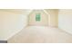 Bonus room features a vaulted ceiling, neutral carpet, and a window with a leafy view at 2589 Lake Erma Dr, Hampton, GA 30228