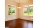 Bright and airy dining area with two windows and hardwood floors, perfect for gatherings at 2589 Lake Erma Dr, Hampton, GA 30228