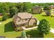 Beautiful two-story brick home with lush landscaping and a well-manicured lawn and traditional architectural details at 2589 Lake Erma Dr, Hampton, GA 30228
