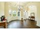Inviting foyer with hardwood floors, large windows, chandelier, and classic wainscoting detail at 2589 Lake Erma Dr, Hampton, GA 30228