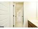 Hallway view featuring multiple doors and views to the second story of the home at 2589 Lake Erma Dr, Hampton, GA 30228