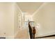 Bright hallway with carpeted floors, crown molding, and wrought iron railing overlooking the foyer below at 2589 Lake Erma Dr, Hampton, GA 30228