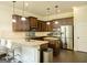 Bright kitchen featuring granite counters, dark wood cabinets, stainless appliances, and a breakfast bar at 2589 Lake Erma Dr, Hampton, GA 30228