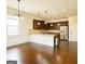 Bright kitchen with stainless steel appliances, dark cabinets, white island, and hardwood floors at 2589 Lake Erma Dr, Hampton, GA 30228