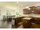 Open concept kitchen with island, granite countertops, dark wood cabinets, stainless steel appliances, and breakfast nook at 2589 Lake Erma Dr, Hampton, GA 30228