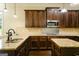 A kitchen boasting granite countertops, dark wood cabinets, and stainless steel appliances at 2589 Lake Erma Dr, Hampton, GA 30228