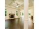 Spacious living room with a fireplace, ceiling fan, and dark hardwood floors at 2589 Lake Erma Dr, Hampton, GA 30228